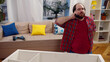 © nimito - Irritated man calling handyman to assemble furniture