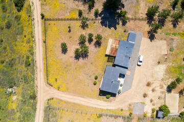 Wall Mural - amazing aerial overhead view of the chilean countryside. a rural house with its farmland and the for