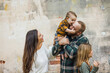 © Ursula Page - A baby boy kissing his dad on the head and mom is looking and laughing and his sister is also in the frame.