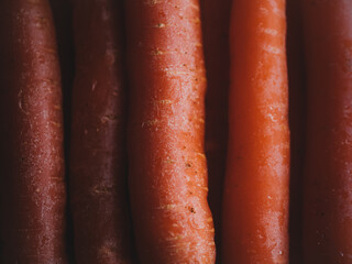 orange food background. close-up of vertically carrots. Bunch of orange organic carrots. natural vegetable food just harvested.