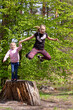 © Nataliia Makarovska - happy little girls jumping from a tree stump in the woods, Lockdown