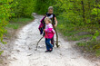 © Nataliia Makarovska - happy two girls are walking in a deciduous forest along a path with sticks, Lockdown