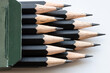 © vvoe - sharp tips of set of black graphite pencils close up in green cartboard box on white background