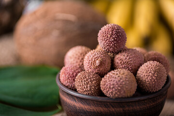 Wall Mural - fresh organic lychee fruit on bamboo basket and old wood background, Blurred background selective focus