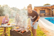 © Impact Photography - People having a poolside barbecue party