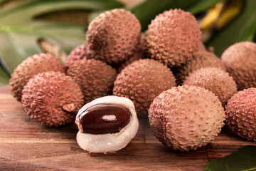 Wall Mural - fresh organic lychee fruit on bamboo basket and old wood background, Blurred background selective focus