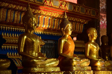 Wall Mural - The golden Buddha image. Reverence in Buddhist sutras At Wat Luang Pothit, Thailand