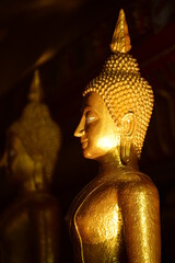 Wall Mural - The golden Buddha image. Reverence in Buddhist sutras At Wat Luang Pothit, Thailand