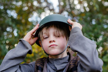 Portrait Of A Small Serious Boy Wearing A Soldier Halloween Costume