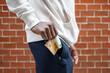© Cavan Images - Close-up of African man pulling out a 50 euro bill from a pocket