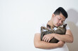 © Igunt - Asian man suffering from depression, he hugs a cute cat to heal his soul
