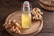 A bottle of natural probiotic drink with ginger on a table