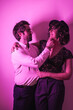 © unai - Studio lifestyle, a young couple in love embraced on Valentine's Day, illuminated with a pink neon light
