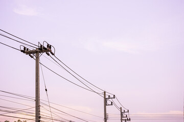 Wall Mural - Electricity pole with silhouette sunset sky, Electricity pylon with shadow of tree in dawn time, Electricity power transmission line on sunset with copy space, Electricity pylon on orange sky