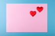 Red hearts on colored background, pink in blue frame, valentine's day greeting card concept