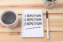 Repetition, Text Words Typography Written On Book Against Wooden Background, Life And Business Motivational Inspirational