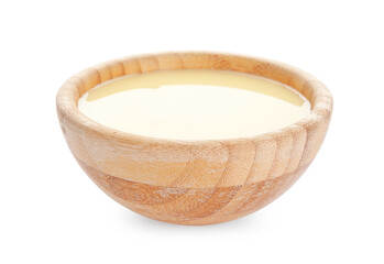 Bowl with sweet condensed milk on white background