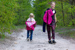 © Nataliia Makarovska - happy two girls are walking in a deciduous forest on a path in spring, Lockdown