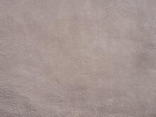 Wall With Beige Pink Grainy Plaster. Texture Not Seamless. Full Screen Photo