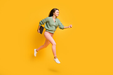 Wall Mural - Full size profile side photo of young pretty happy business woman run in air with laptop in hand isolated on yellow color background
