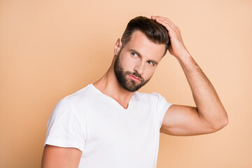 Wall Mural - Photo of young handsome man enjoy hair care treatment lotion hairdo look empty space isolated over beige color background