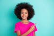 © deagreez - Photo portrait of smiling afro american girl pointing finger at blank space isolated on vivid cyan colored background