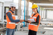 © Supavadee - A male engineer with a female institute wearing an accident prevention helmet and shaking hands introduces himself in a construction project.