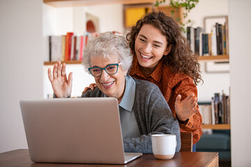 Grandmother and granddaughter doing video call with laptop