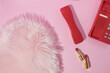 © Adela - Bright red retro design handset phone with red and pink golden lipsticks and pastel pink faux fur. Romantic retro style aesthetic background. Minimal flat lay handset.