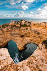 heart-shaped cliffs on the shore of atlantic ocean in algarve, portugal. selective focus. beautiful 