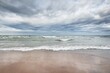 © Aastels - Panoramic view of the Baltic sea from a sandy shore (sand dunes). Dramatic sky with glowing clouds, waves and water splashes. Idyllic seascape. Warm winter weather, climate change, nature. Denmark