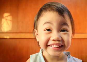 Wall Mural - Charming 3 years old Asian Thai little girl smilling at home.