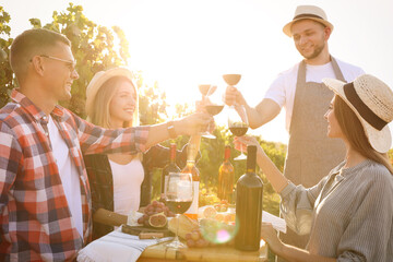 Poster - Friends holding glasses of wine and having fun in vineyard