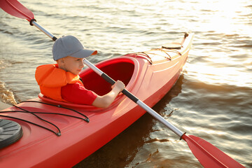 Poster - Little boy kayaking on river. Summer camp activity