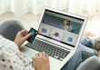 © New Africa - Woman with credit card using laptop for online shopping indoors, closeup