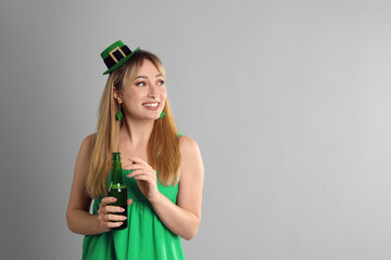 Sticker - Happy woman in St Patrick's Day outfit with beer on light grey background, space for text