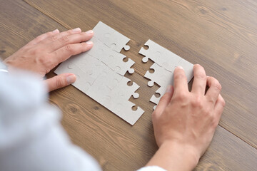 Wall Mural - Image of businesswoman connecting elements of white puzzle