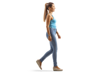 Full length profile shot of a young female with a long ponytail walking