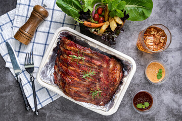 Wall Mural - Grilled pork ribs with Vegetables and sauces on a drak table