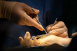 © Cavan Images - a surgeon operates a hand