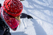 © Cavan Images - horizontal top view of woman hand wearing a red leather glove and drawing a heart shape in the snow with the index finger, concept for love, winter time