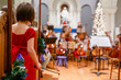 © Cavan Images - A small girl stands with cello bow in hand waiting her turn to perform