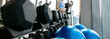 © kowitstockphoto - woman wearing sports clothes weighing dumbbells in hands during workout in gym