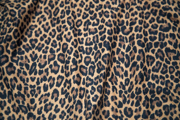 Leopard print pattern fabric texture repeat background effect leopard fabric sample.