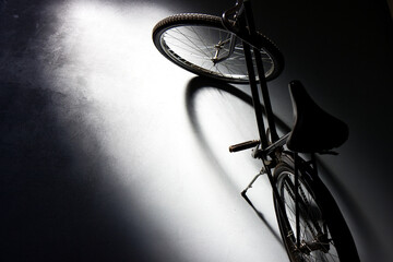 Sticker - High angle  shot of a vintage bicycle parked in a dark garage