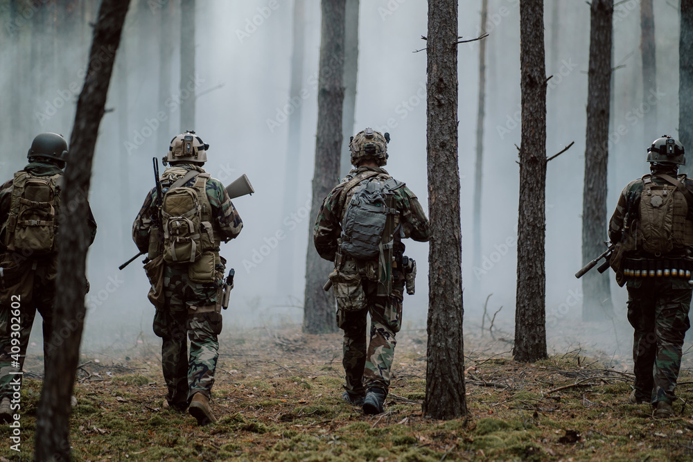 Squad of Four Fully Equipped Soldiers in Camouflage on a Reconnaissance ...
