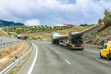 Canvas Print - Several special transport trucks on the road transporting wind turbine blades.