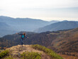 © Alexander - tourist stands on top of a mountain with her arms outstretched, Hiking in the mountains.