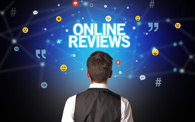 rear view of a businessman with online reviews inscription, social networking concept