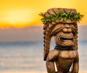 Hawaiian Tiki Statue with an amazing sunrise in the background. The tiki is dressed up with traditional leaves and a macadamia necklace. It is made of wood and looks large in size.